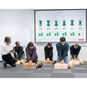 A CPR Instructor Monitoring Students Training on Little Anne QCPR Enabled Adult CPR Manikins with the QCPR App.