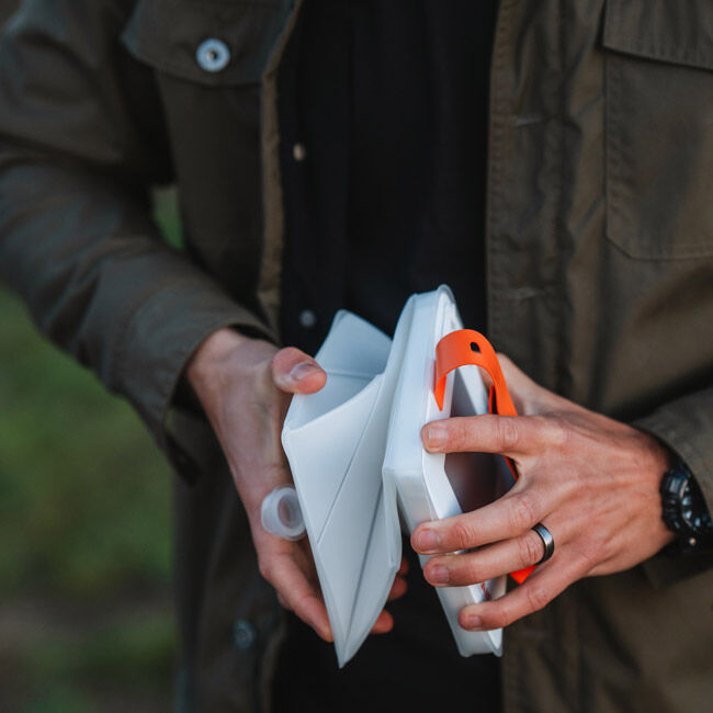 A person inflating the LuminAID Max QI Lantern.