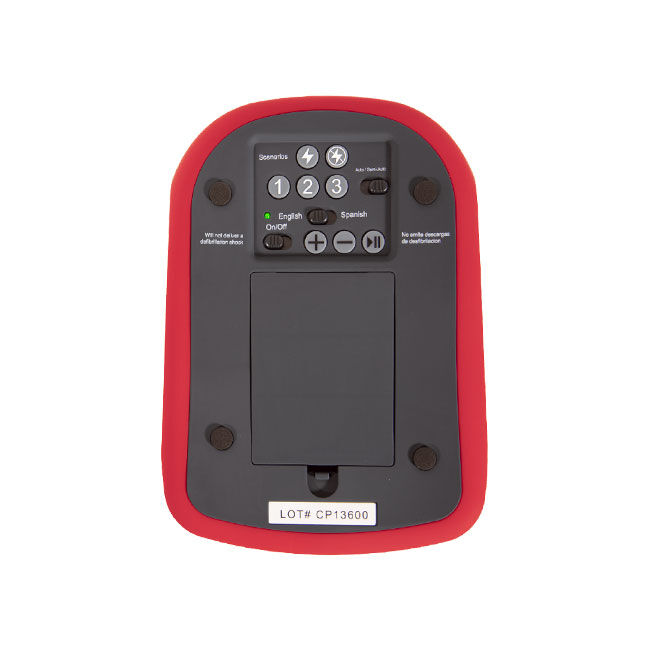 Back of the AED Trainer showing scenario buttons, shock setting toggles, language toggles, on/off switch, pause button, volume control, and battery compartment.