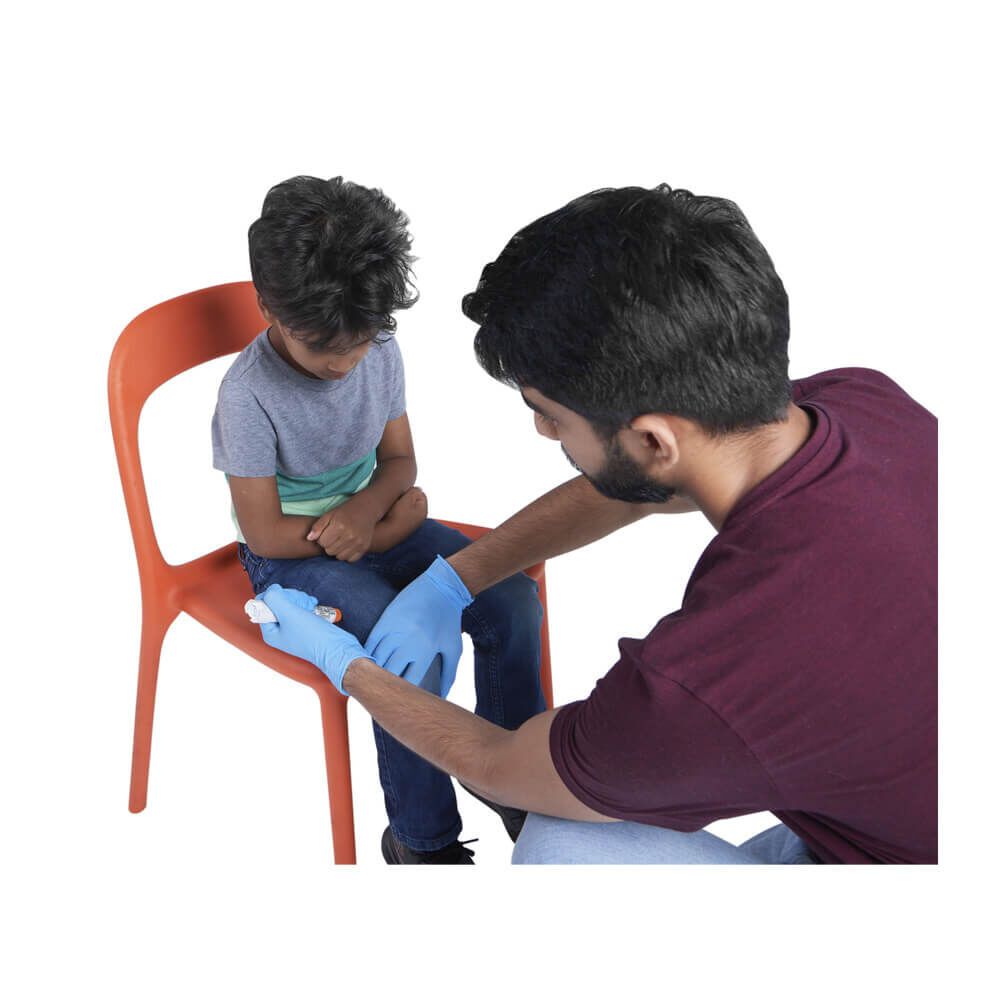 An instructor showing a child how to use an EPI Pen with the Epinephrine Auto Injector Training Device.