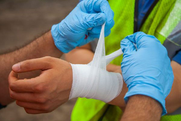 A construction worker bandages an injured coworker in Ohio.